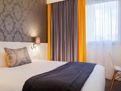 Un ou plusieurs lits dans un hébergement de l'établissement Hotel Kyriad Tours St Pierre des Corps Gare