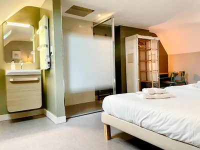 Un ou plusieurs lits dans un hébergement de l'établissement Gite de la Tour SPA PRIVÉ