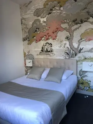 Un ou plusieurs lits dans un hébergement de l'établissement Hôtel Saint Eloi