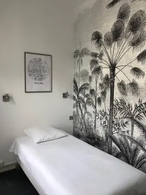 Un ou plusieurs lits dans un hébergement de l'établissement Hôtel Saint Eloi