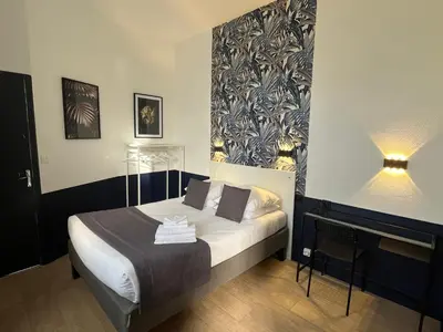 Un ou plusieurs lits dans un hébergement de l'établissement Hôtel Saint Eloi
