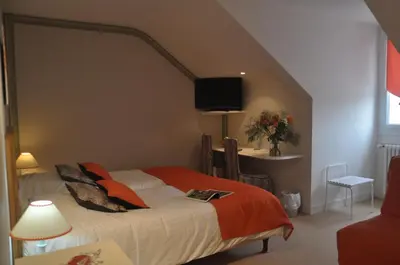 Un ou plusieurs lits dans un hébergement de l'établissement Logis Auberge Du Centre