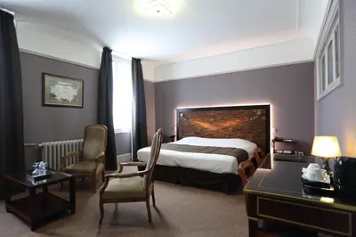 Un ou plusieurs lits dans un hébergement de l'établissement Le Grand Hotel