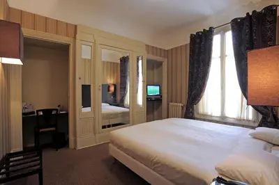 Un ou plusieurs lits dans un hébergement de l'établissement Le Grand Hotel