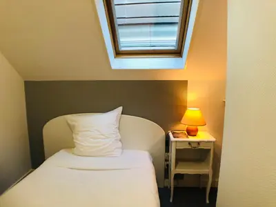 Un ou plusieurs lits dans un hébergement de l'établissement Cit'Hotel Le Volney