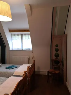Un ou plusieurs lits dans un hébergement de l'établissement Le Manoir du Gouverneur