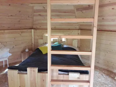 Un ou plusieurs lits dans un hébergement de l'établissement CABANE DANS LES ARBRES