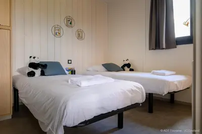 Un ou plusieurs lits dans un hébergement de l'établissement Cottages du Golf Fleuray-Amboise