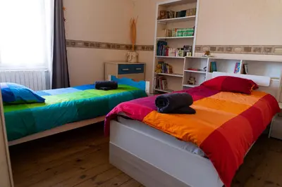 Un ou plusieurs lits dans un hébergement de l'établissement Cocottes & Colibri