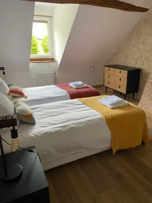 Un ou plusieurs lits dans un hébergement de l'établissement La Charmeraie : gîte de charme, piscine et spa