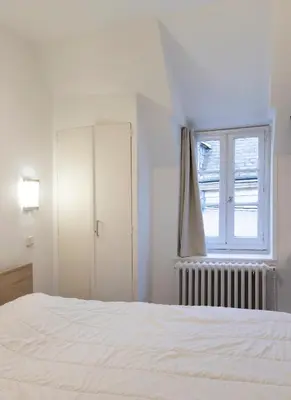 Un ou plusieurs lits dans un hébergement de l'établissement Hôtel Du Bellay