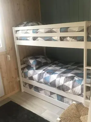 Un ou plusieurs lits dans un hébergement de l'établissement Gîte chalet-piscine 