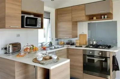 Cuisine ou kitchenette dans l'établissement Camping 4* 3 CH 2 SDB- Lave linge- Lave vaisselle