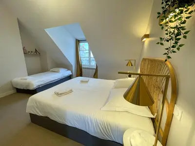 Un ou plusieurs lits dans un hébergement de l'établissement Maison des fleurs