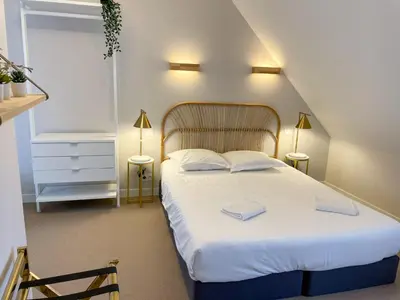 Un ou plusieurs lits dans un hébergement de l'établissement Maison des fleurs