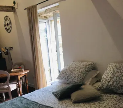 Un ou plusieurs lits dans un hébergement de l'établissement Studio la Grange