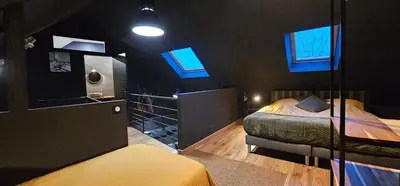 Un ou plusieurs lits dans un hébergement de l'établissement PADDOCK 24 Arnage - Loft Le Mans