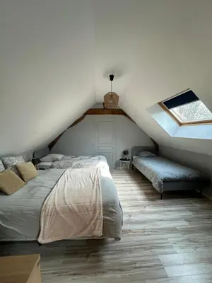 Un ou plusieurs lits dans un hébergement de l'établissement Gîte la grande racinaie