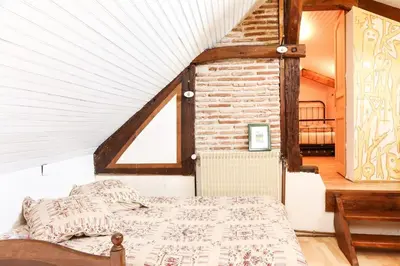 Un ou plusieurs lits dans un hébergement de l'établissement Charmante maison jardin à 100 mètres du Clos Lucé