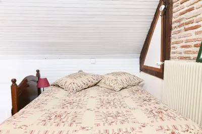 Un ou plusieurs lits dans un hébergement de l'établissement Charmante maison jardin à 100 mètres du Clos Lucé
