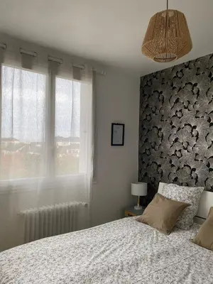 Un ou plusieurs lits dans un hébergement de l'établissement Appartement cosy près de la gare avec parking