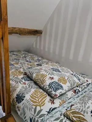 Un ou plusieurs lits dans un hébergement de l'établissement Maisons de campagne. Gîte vert.